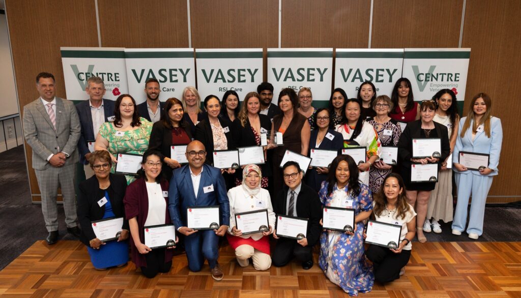 Group of staff with award certificates